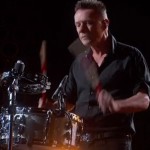 Larry seemingly winces while playing drums at the Academy Awards. 